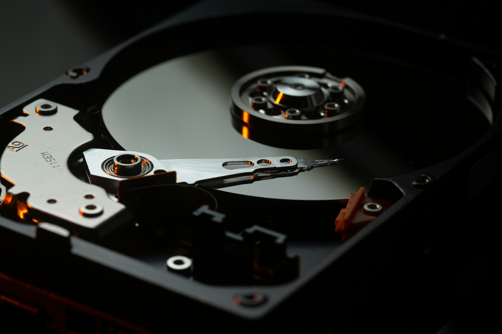 Inside a hard drive — read/write head over the platter, where data recovery in Perth begins